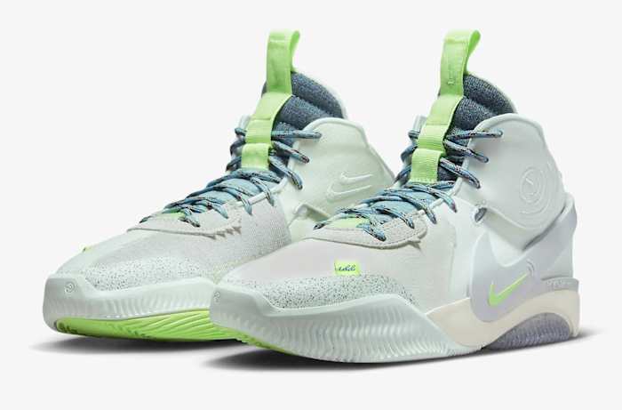 Side view of green and blue Nike shoes.